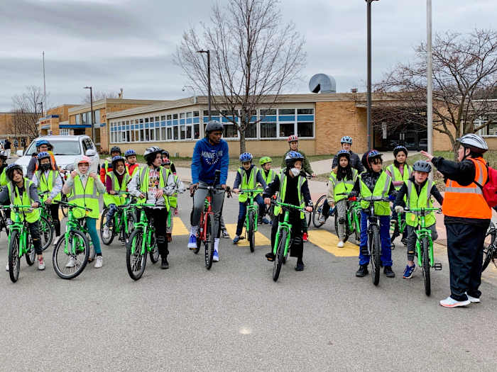 Minnesota Lynx star Sylvia Fowles rides her bike alongside students from Minneapolis’ Bryn Mawr Elementary School.